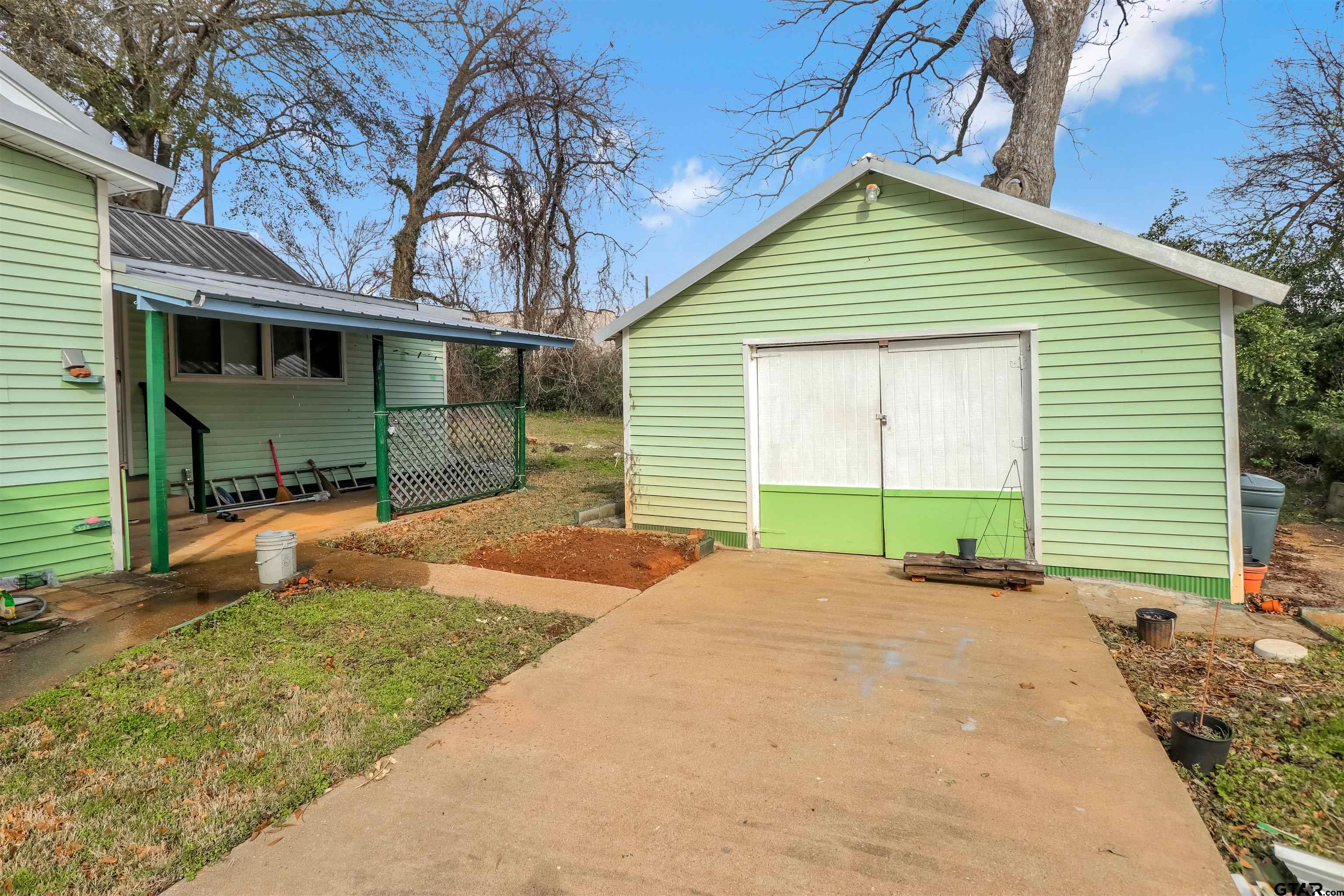 205 East 4th Street Rusk, TX 75785 - Photo 22 of 23 a view of a house with a yard and potted plants