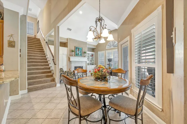 a view of a dining room with furniture and chandelier