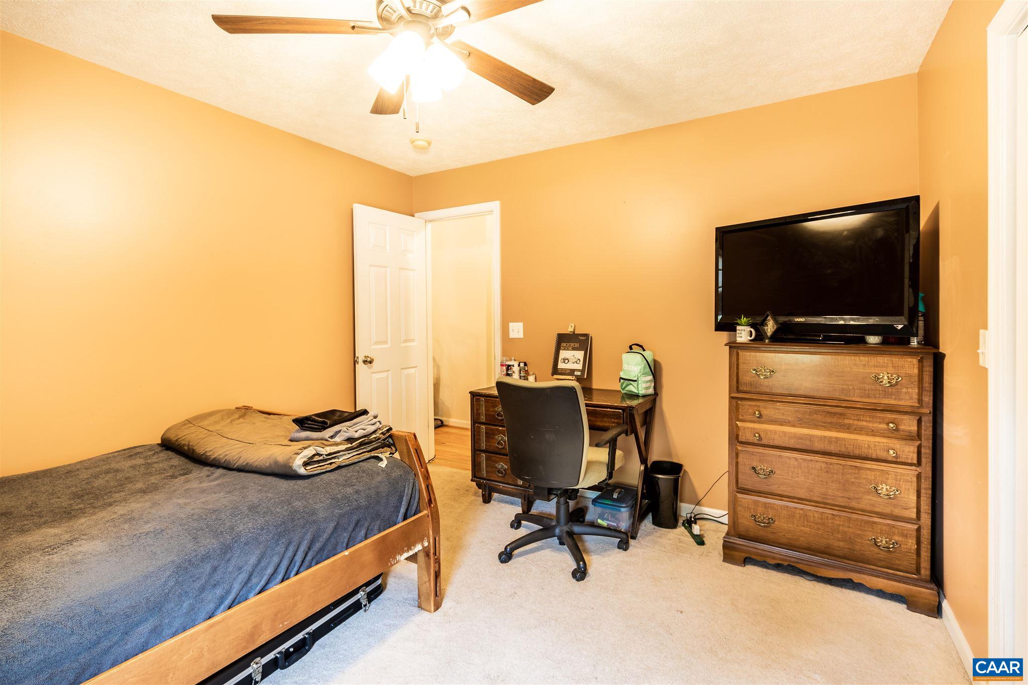 196 Logtrac Road Stanardsville, VA 22973 - Photo 25 of 34 a bedroom with bed and a flat screen tv