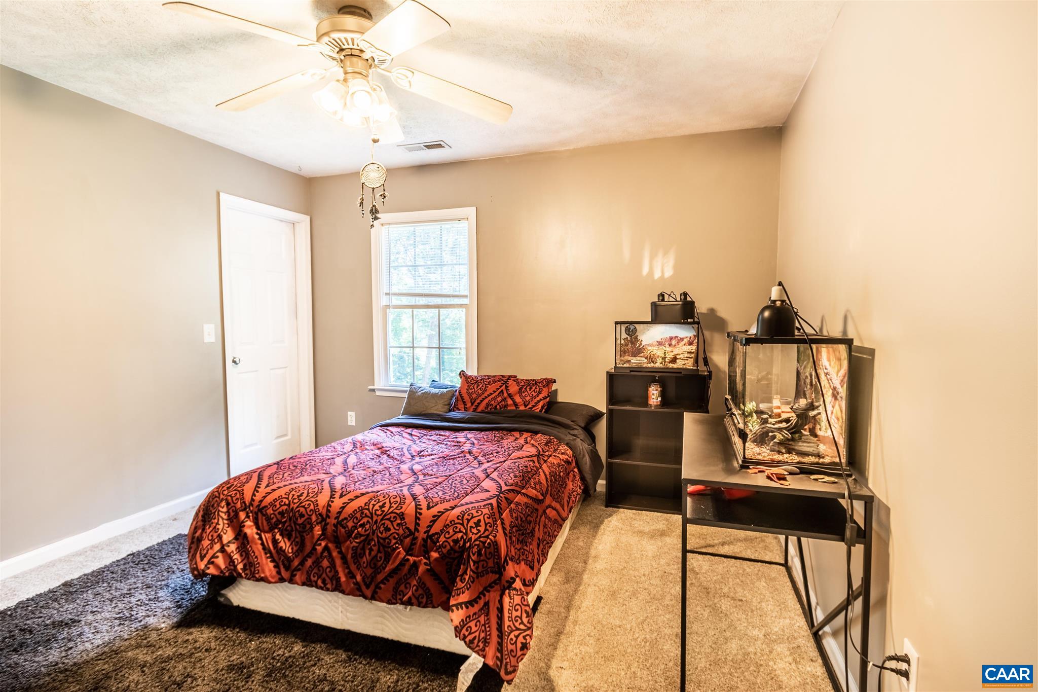 196 Logtrac Road Stanardsville, VA 22973 - Photo 26 of 34 a bedroom with a bed and wooden floor