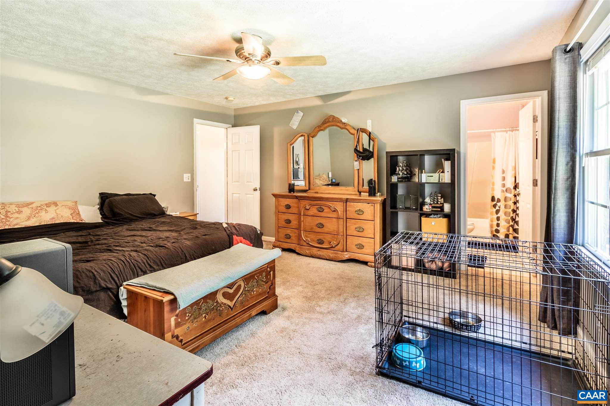 196 Logtrac Road Stanardsville, VA 22973 - Photo 32 of 34 a bedroom with a bed and wooden floor