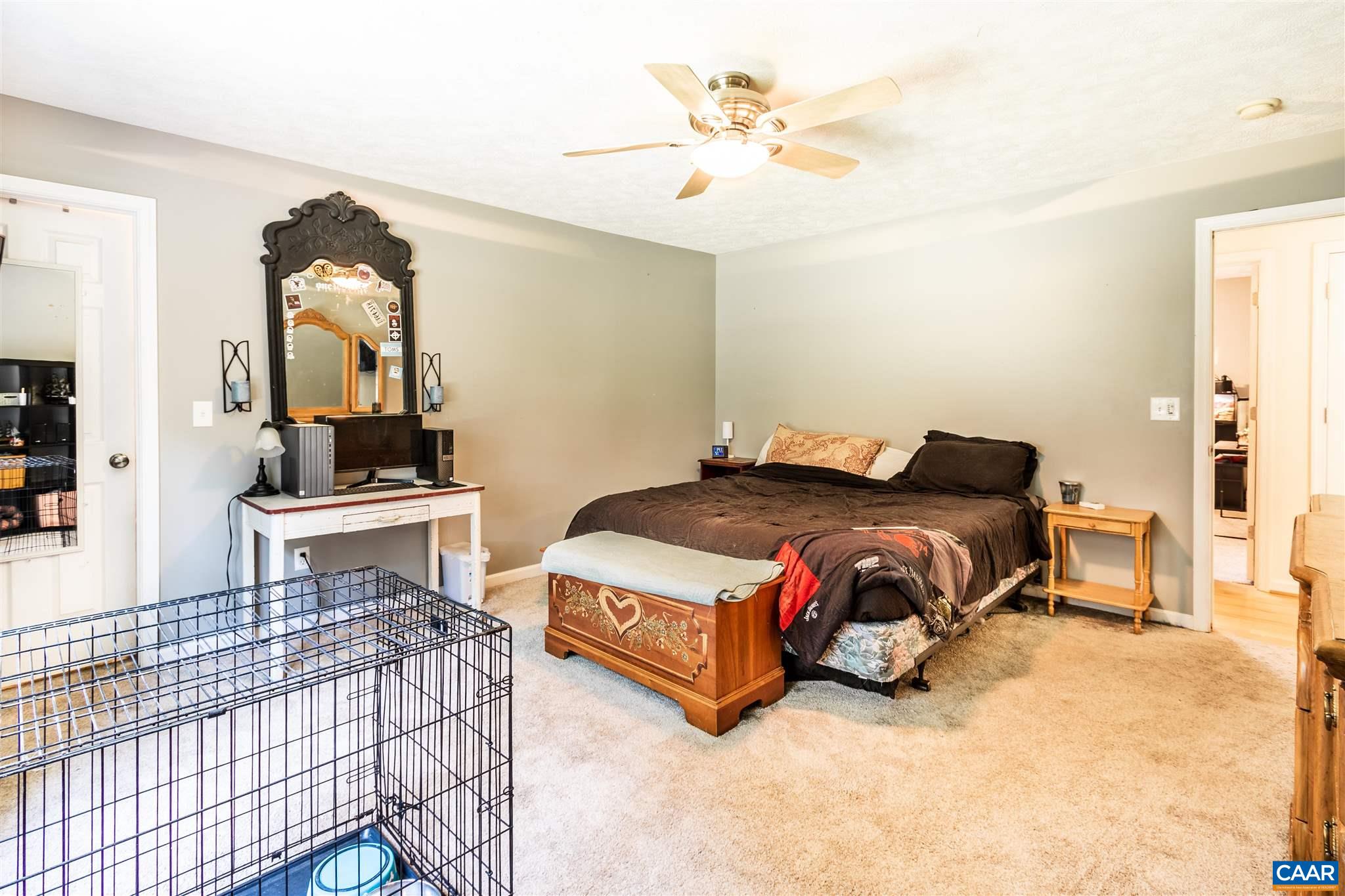 196 Logtrac Road Stanardsville, VA 22973 - Photo 34 of 34 a bedroom with a bed and a chandelier