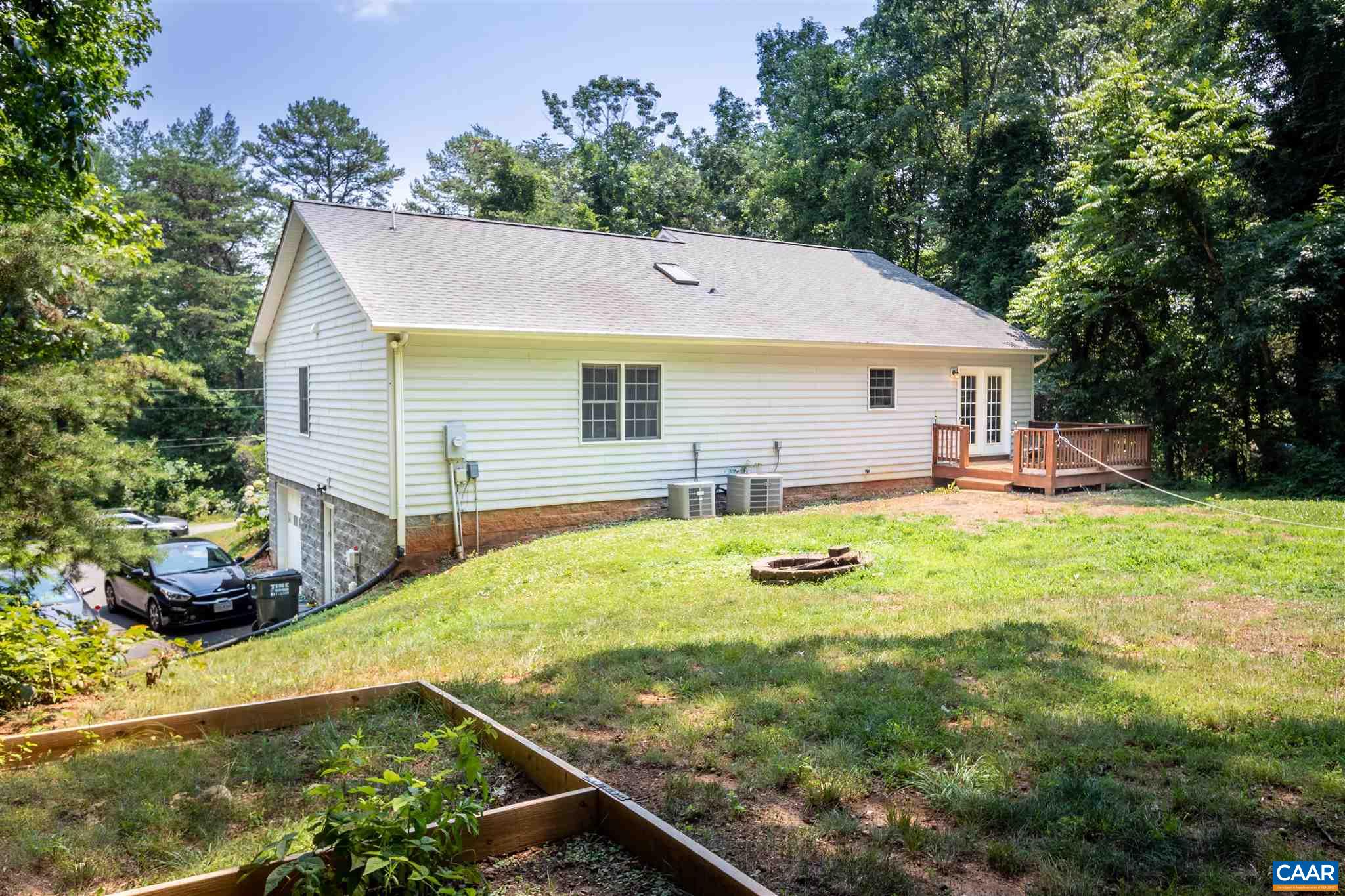 196 Logtrac Road Stanardsville, VA 22973 - Photo 5 of 34 a view of a backyard with table and chairs under an umbrella