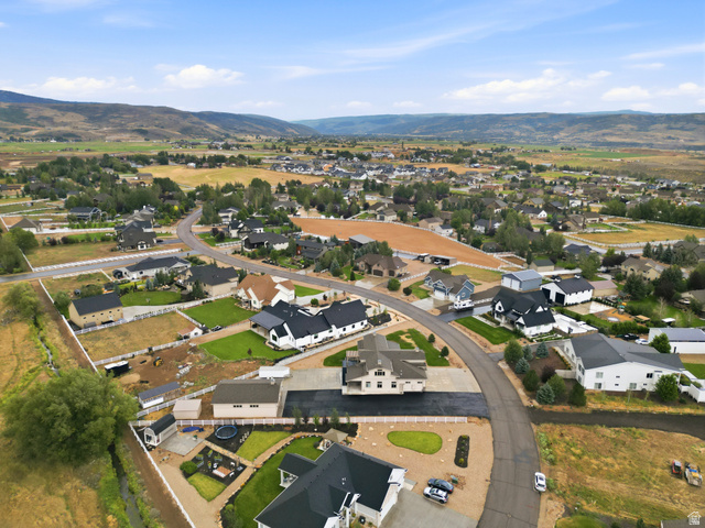 560 Aspen Road Francis, UT 84036 - Photo 6 of 59 Aerial view showcasing a modern residential property featuring a contemporary black-roof design with manicured landscaping, circular driveway, and expansive grounds