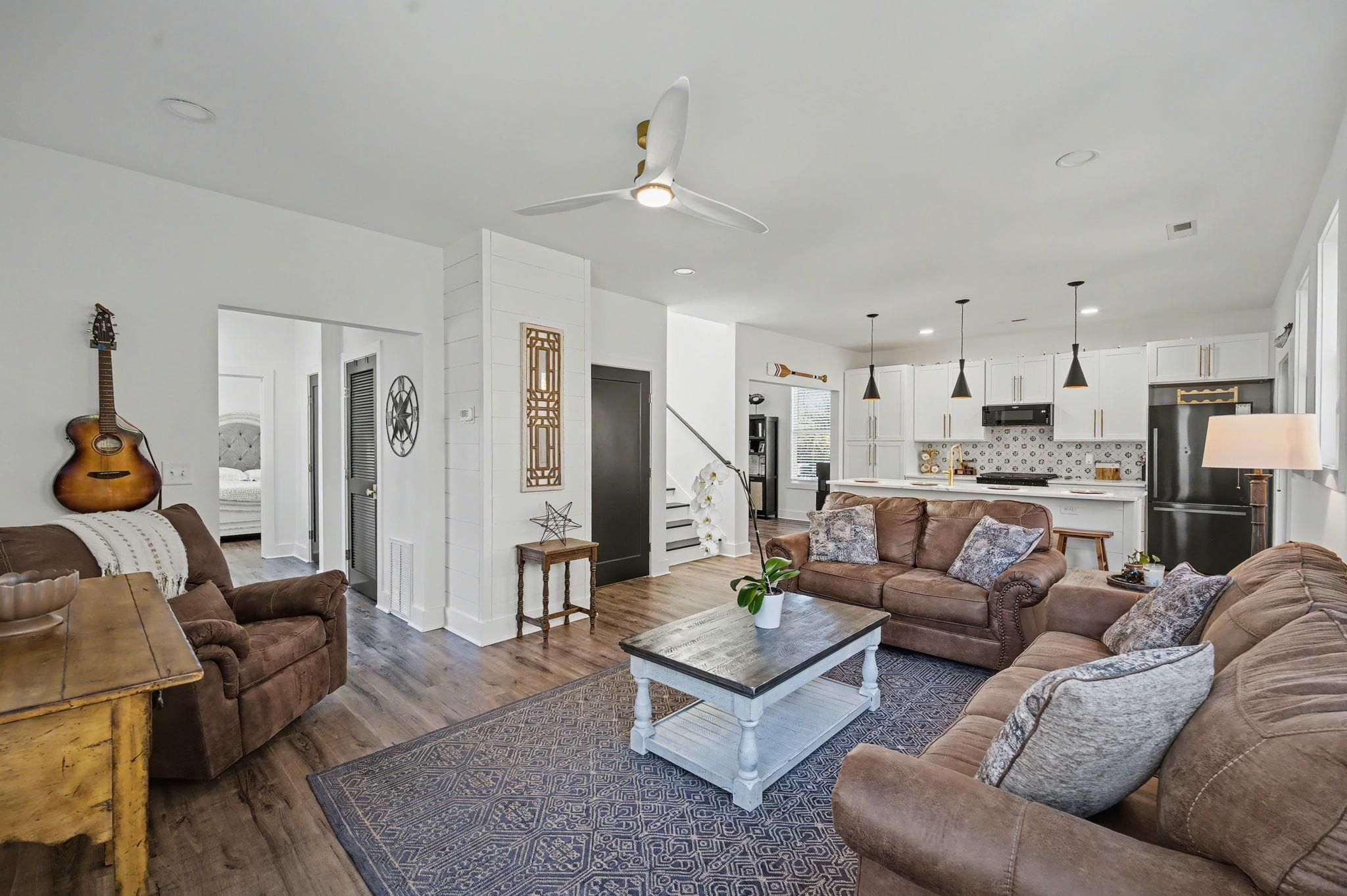 236 Brown Pelican Loop Pawleys Island, SC 29585 - Photo 15 of 38 Living area with a ceiling fan, dark wood-type flooring, recessed lighting, and stairway