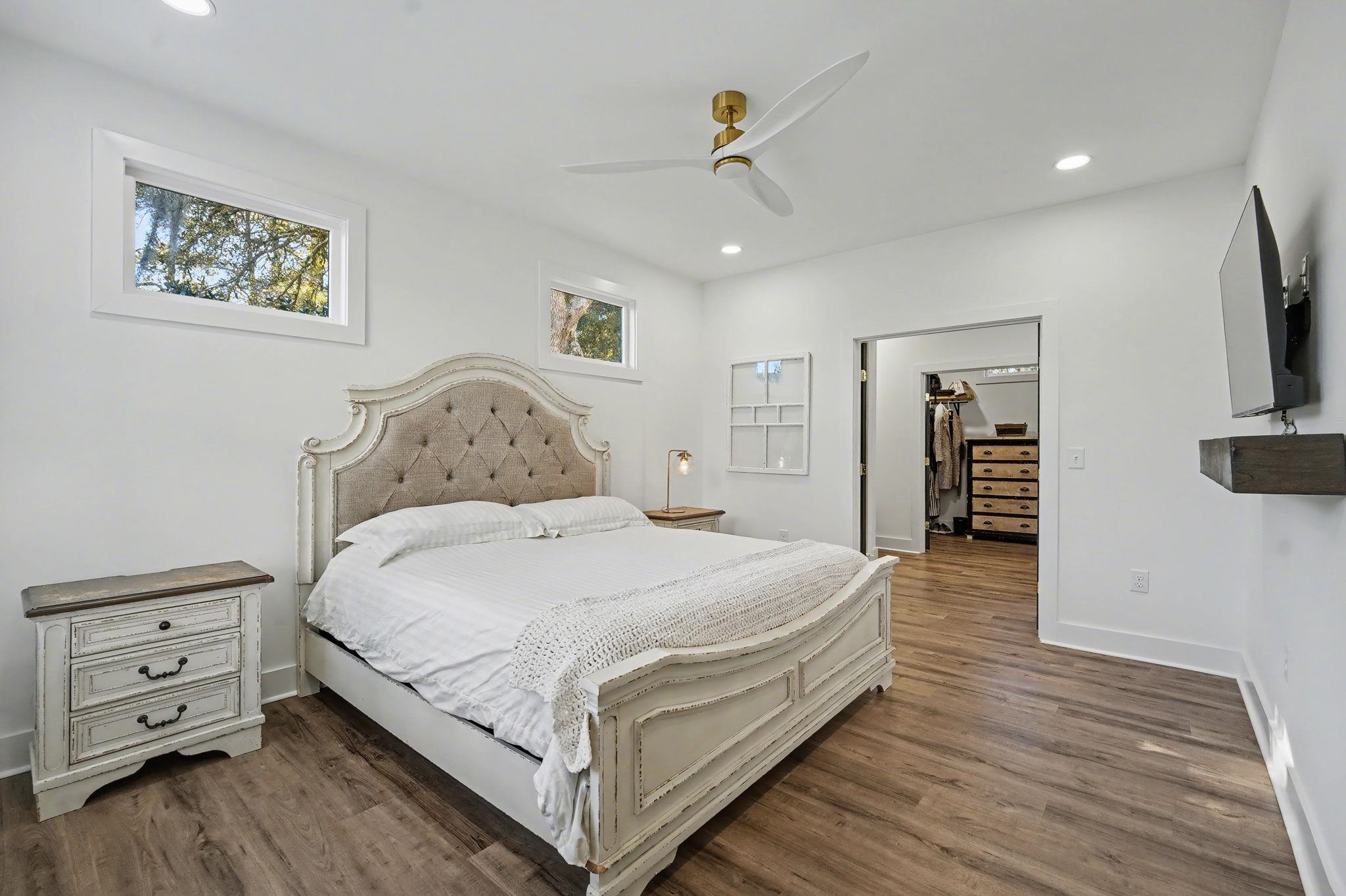 236 Brown Pelican Loop Pawleys Island, SC 29585 - Photo 25 of 38 Bedroom featuring a spacious closet, recessed lighting, dark wood-style floors, and a ceiling fan