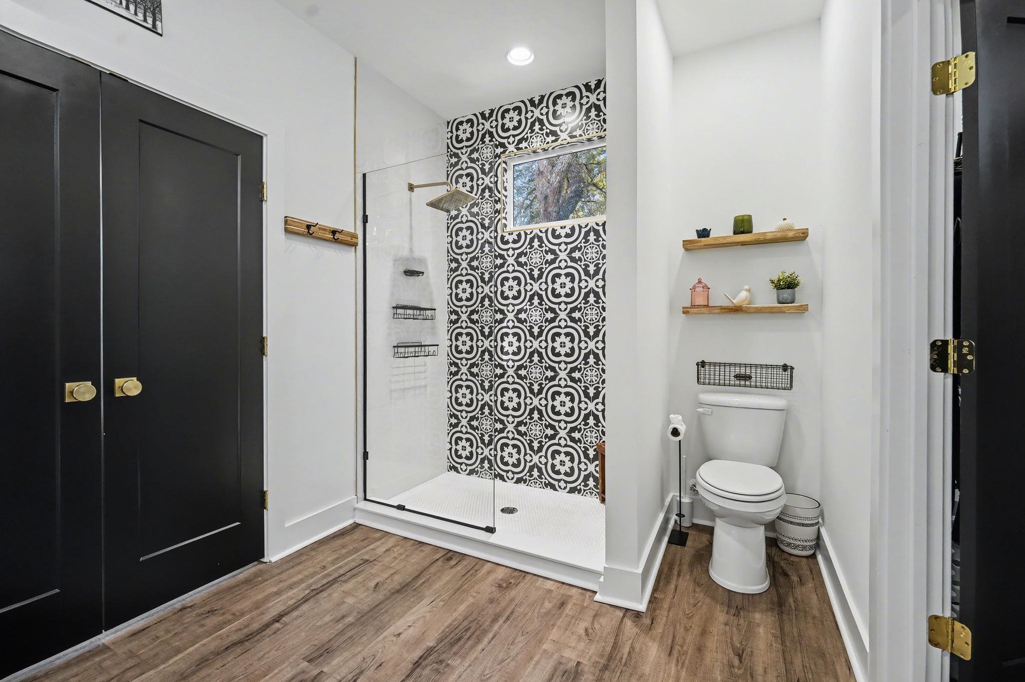 236 Brown Pelican Loop Pawleys Island, SC 29585 - Photo 27 of 38 Full bath with a tile shower and wood finished floors