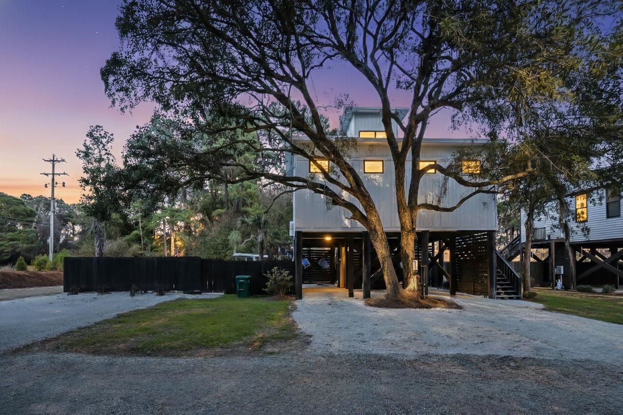 236 Brown Pelican Loop Pawleys Island, SC 29585 - Photo 3 of 38 Coastal inspired home featuring a carport, stairs, and driveway