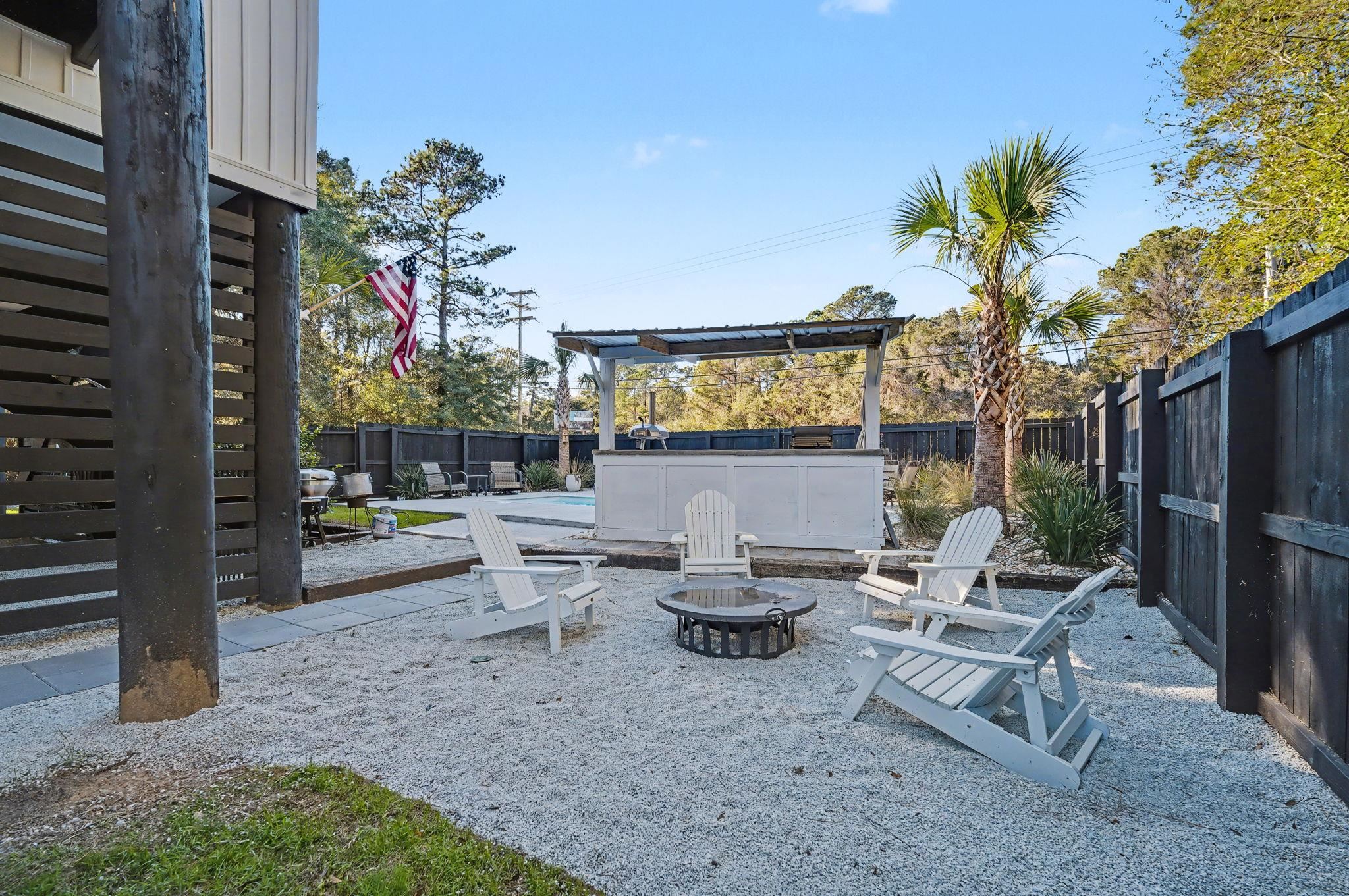 236 Brown Pelican Loop Pawleys Island, SC 29585 - Photo 6 of 38 Fenced backyard featuring a patio, an outdoor fire pit.