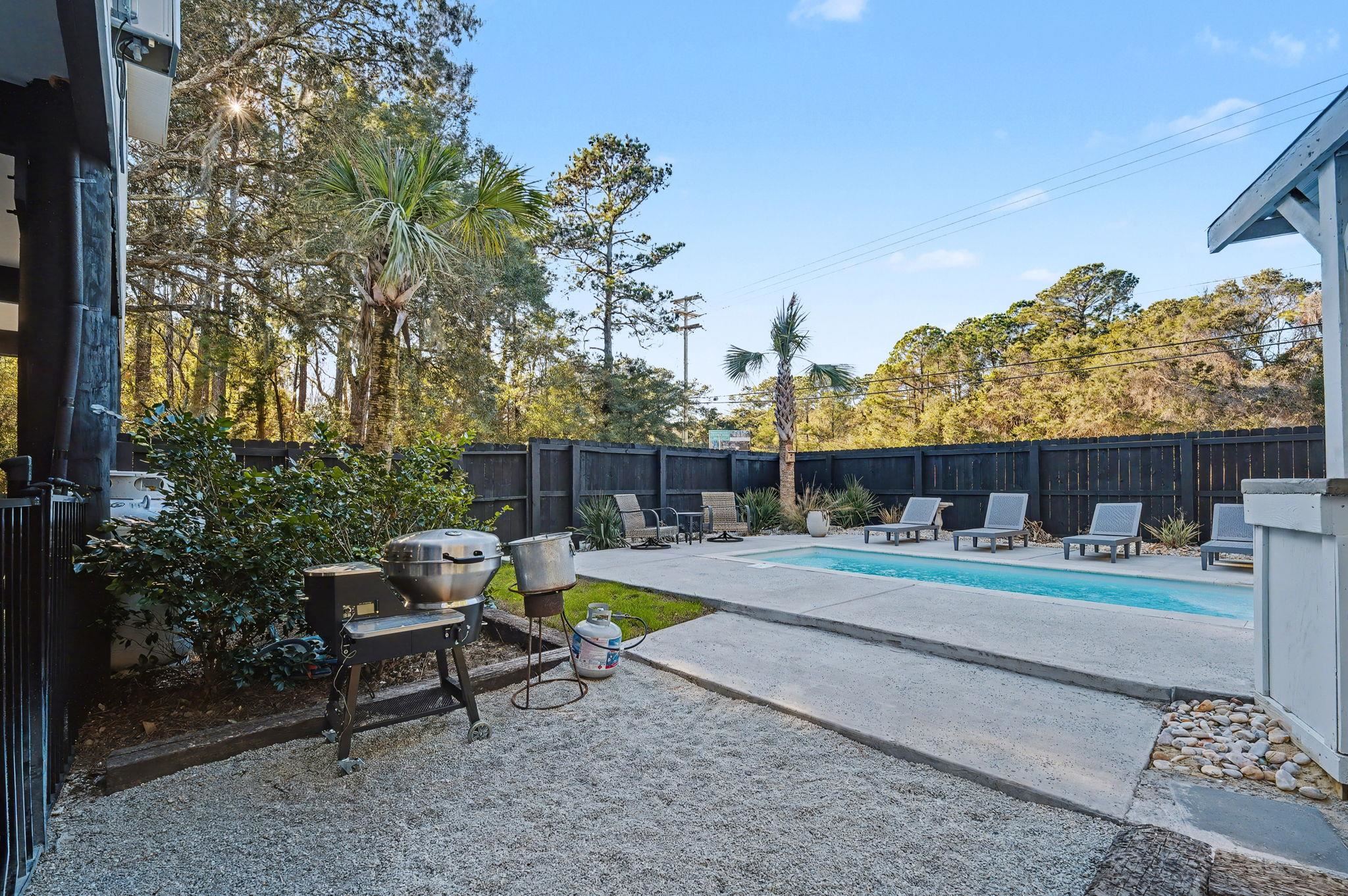 236 Brown Pelican Loop Pawleys Island, SC 29585 - Photo 10 of 38 View of pool featuring a patio area, a grill, and a fenced backyard