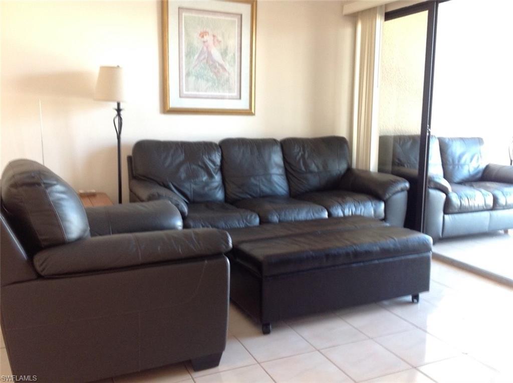 803 River Point Drive, Unit 202B Naples, FL 34102 - Photo 13 of 24 a living room with a couch and a window