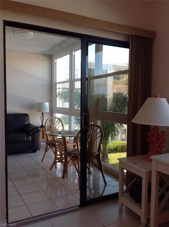 803 River Point Drive, Unit 202B Naples, FL 34102 - Photo 16 of 24 a dining room with furniture and window