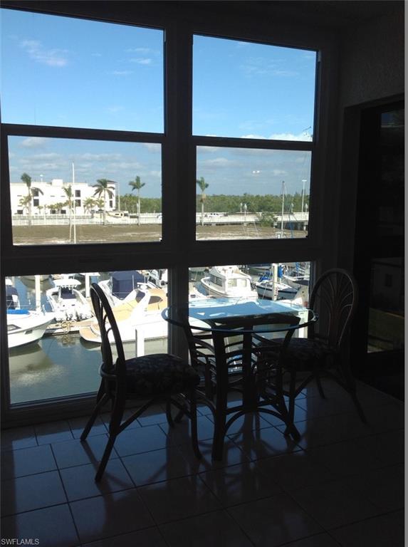 803 River Point Drive, Unit 202B Naples, FL 34102 - Photo 19 of 24 a view of a dining room with furniture and window