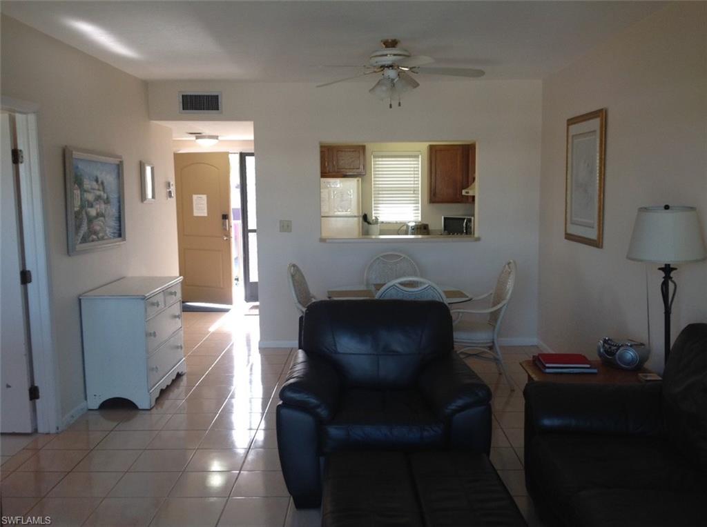 803 River Point Drive, Unit 202B Naples, FL 34102 - Photo 23 of 24 a living room with furniture and a window