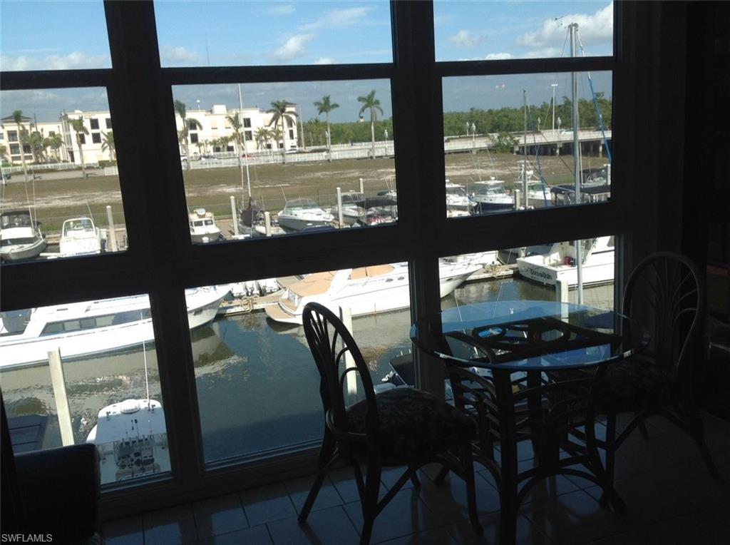 803 River Point Drive, Unit 202B Naples, FL 34102 - Photo 5 of 24 a view of a dining room with furniture window and outside view