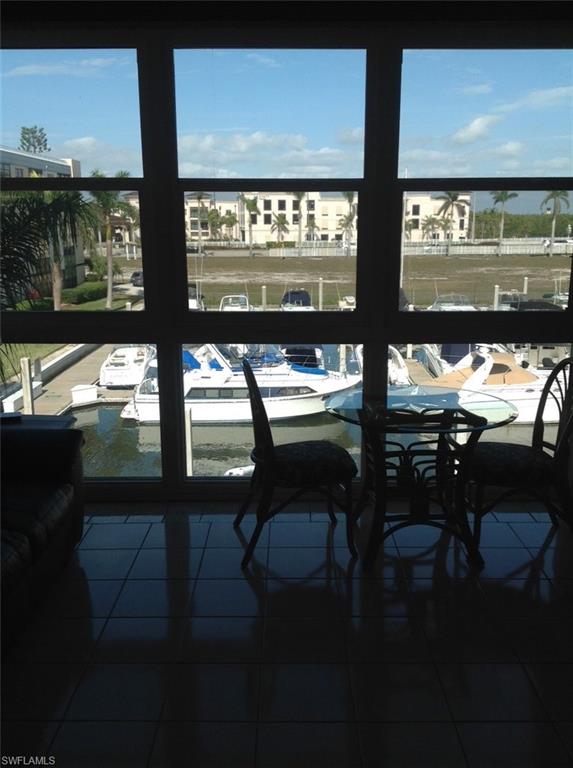 803 River Point Drive, Unit 202B Naples, FL 34102 - Photo 6 of 24 a view of a room with lots of wooden furniture