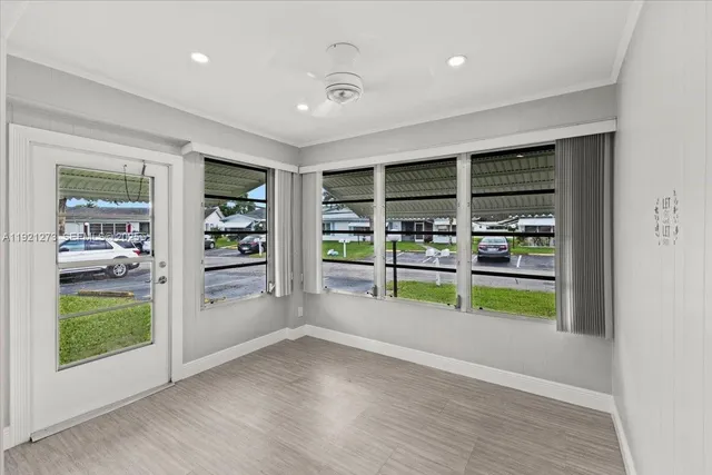 an empty room with wooden floor and a fireplace