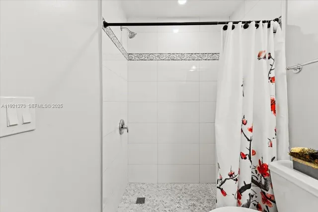 a bathroom with a shower and a sink