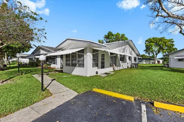 a view of a house with a backyard porch and sitting area