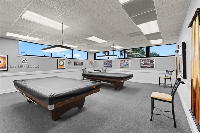 a living room with furniture a table tennis table and chairs