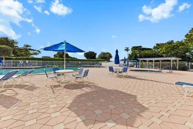 a view of a swimming pool and lounge chairs