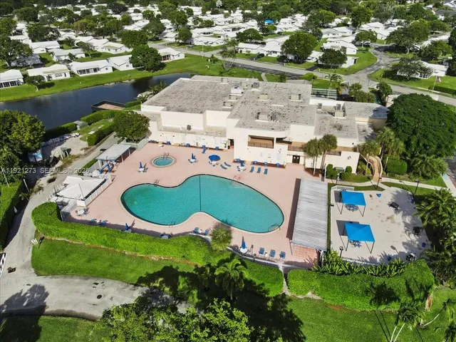 an aerial view of a house with a swimming pool yard and outdoor seating