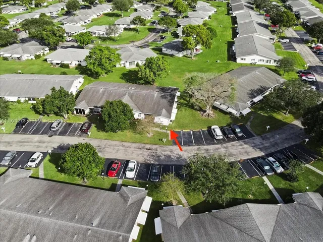 an aerial view of a house with a garden and mountain view in back