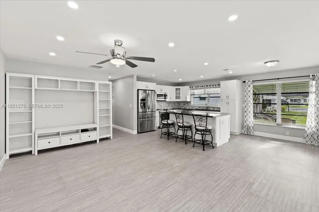 an empty room with wooden floor and furniture