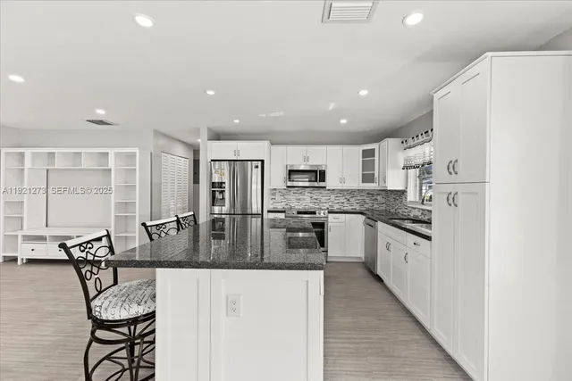 a kitchen with counter top space cabinets and stainless steel appliances
