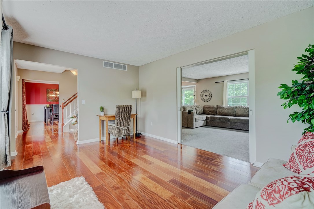 809 Lindsey Circle Webster, NY 14580 - Photo 21 of 50 LIVING ROOM VIEW TO THE FAMILY ROOM AND FOYER/ENTR