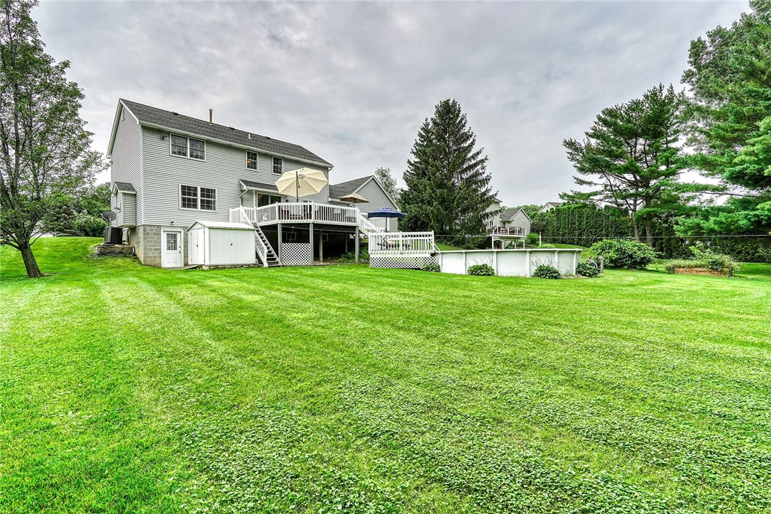 809 Lindsey Circle Webster, NY 14580 - Photo 41 of 50 VIEW TO THE WALK-OUT BASEMENT, SHED, POOL, & DECK!