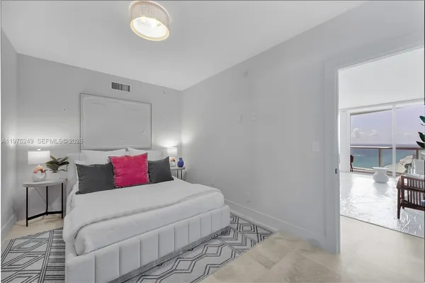 a bedroom with a bed and chandelier