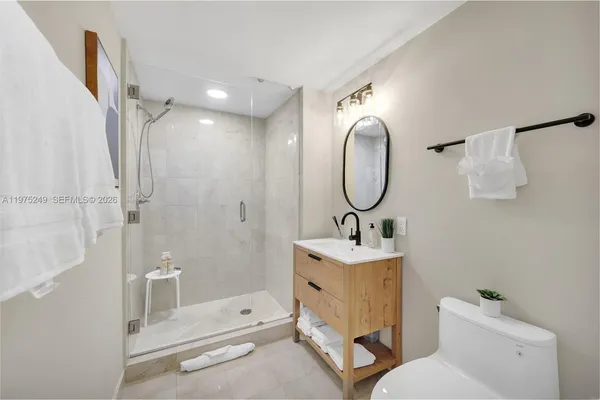 a bathroom with a sink toilet and shower