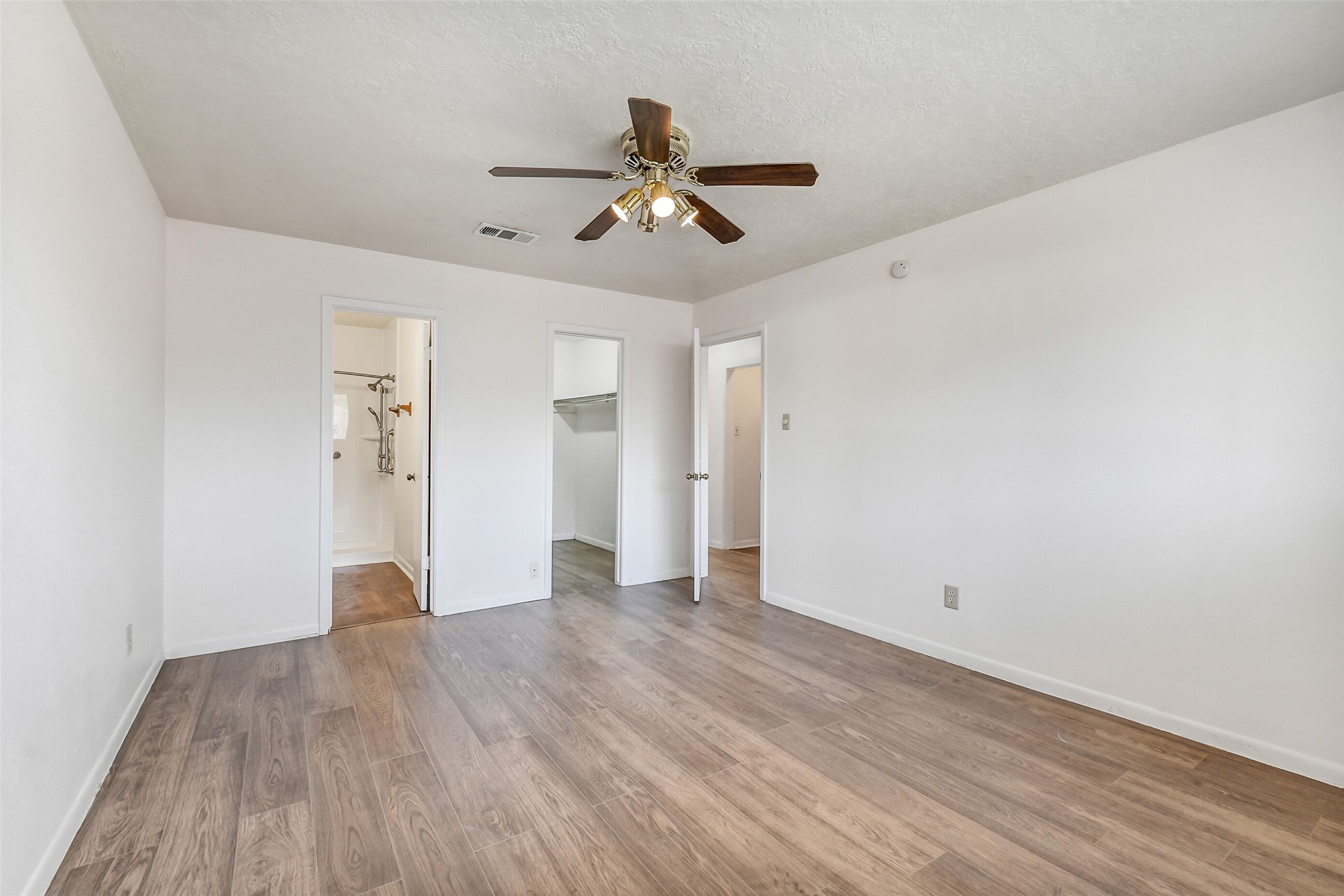 217 Lazy Lane Conroe, TX 77301 - Photo 18 of 28 a view of empty room with wooden floor