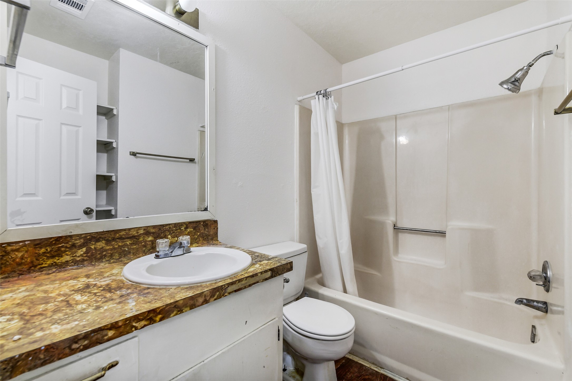 217 Lazy Lane Conroe, TX 77301 - Photo 25 of 28 a bathroom with a granite countertop sink toilet and shower