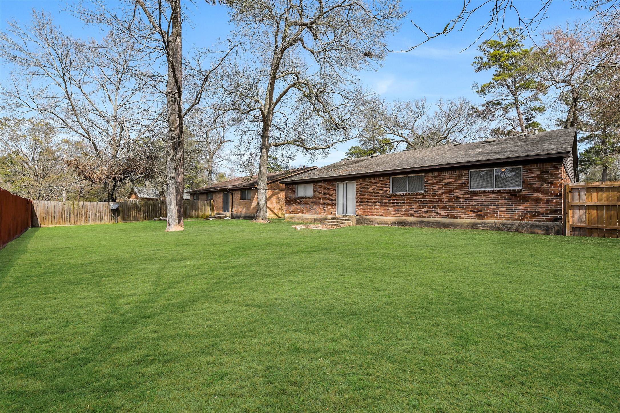 217 Lazy Lane Conroe, TX 77301 - Photo 28 of 28 a view of a house with a yard