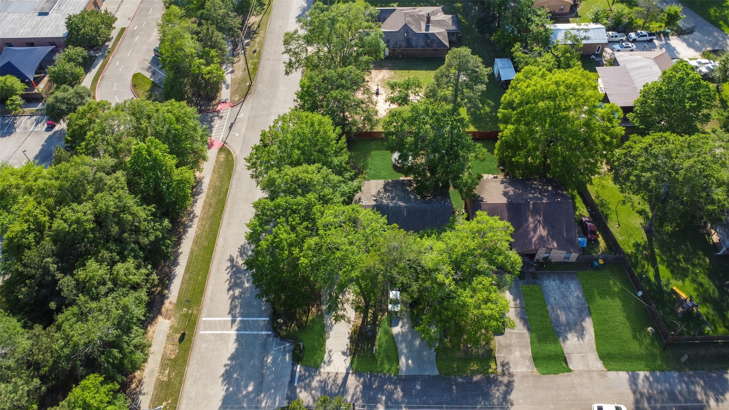217 Lazy Lane Conroe, TX 77301 - Photo 3 of 28 an aerial view of residential house with outdoor space and trees all around