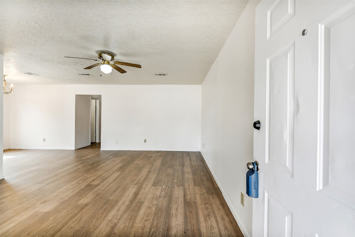 217 Lazy Lane Conroe, TX 77301 - Photo 5 of 28 a view of a room with wooden floor and white walls
