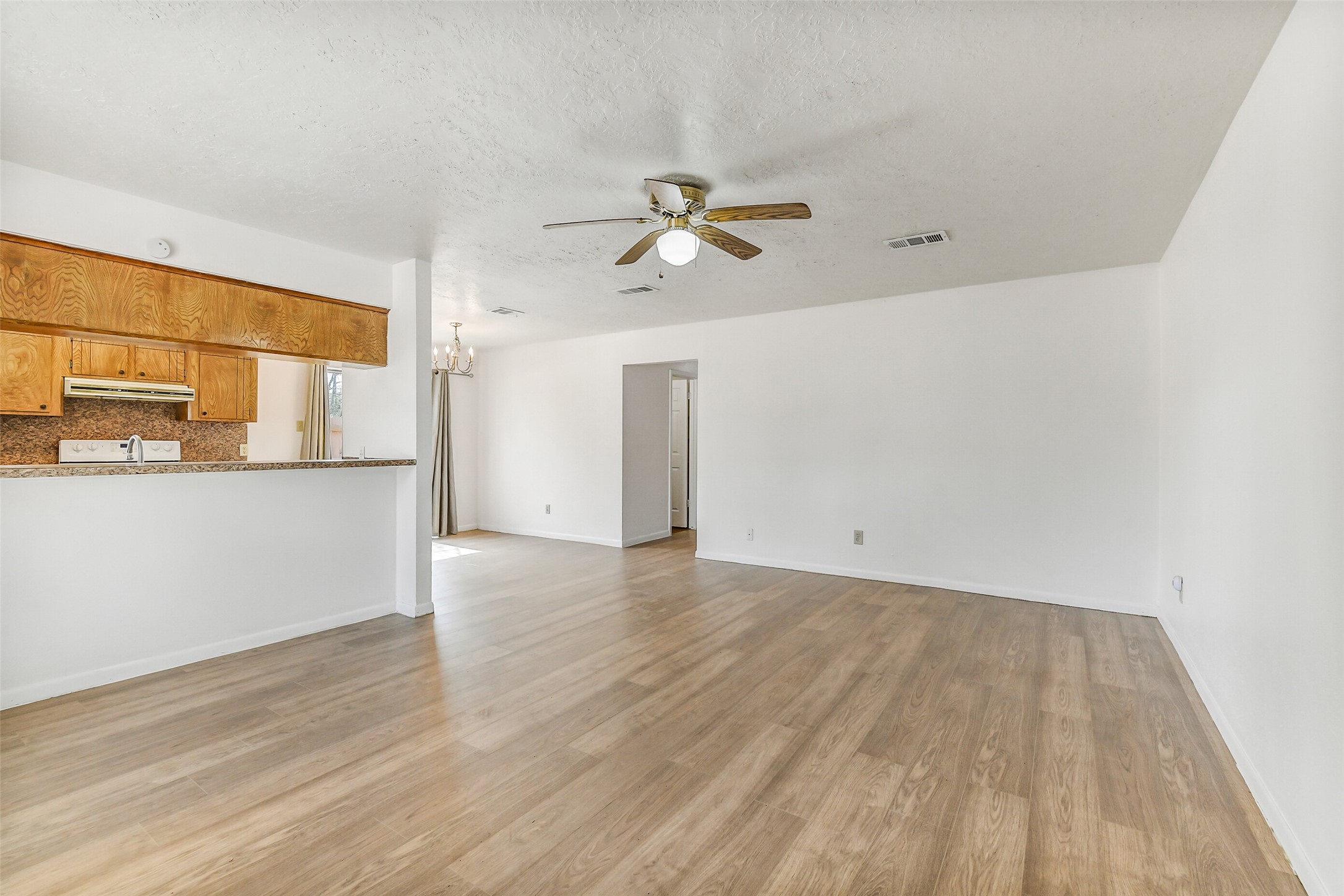 217 Lazy Lane Conroe, TX 77301 - Photo 6 of 28 a view of a room with wooden floor and a ceiling fan