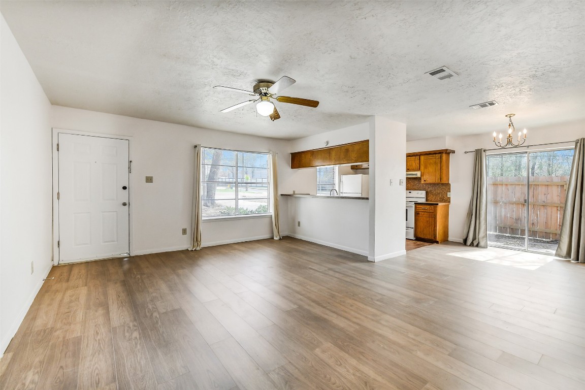 217 Lazy Lane Conroe, TX 77301 - Photo 8 of 28 a view of an empty room with a window and wooden floor