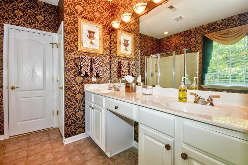 7725 Monte Alto Drive Raleigh, NC 27613 - Photo 18 of 25 Large Master bathroom features a garden tub to soak in, separate stand alone shower, double sinks, tile flooring and a separate water closet. Master Bathroom
