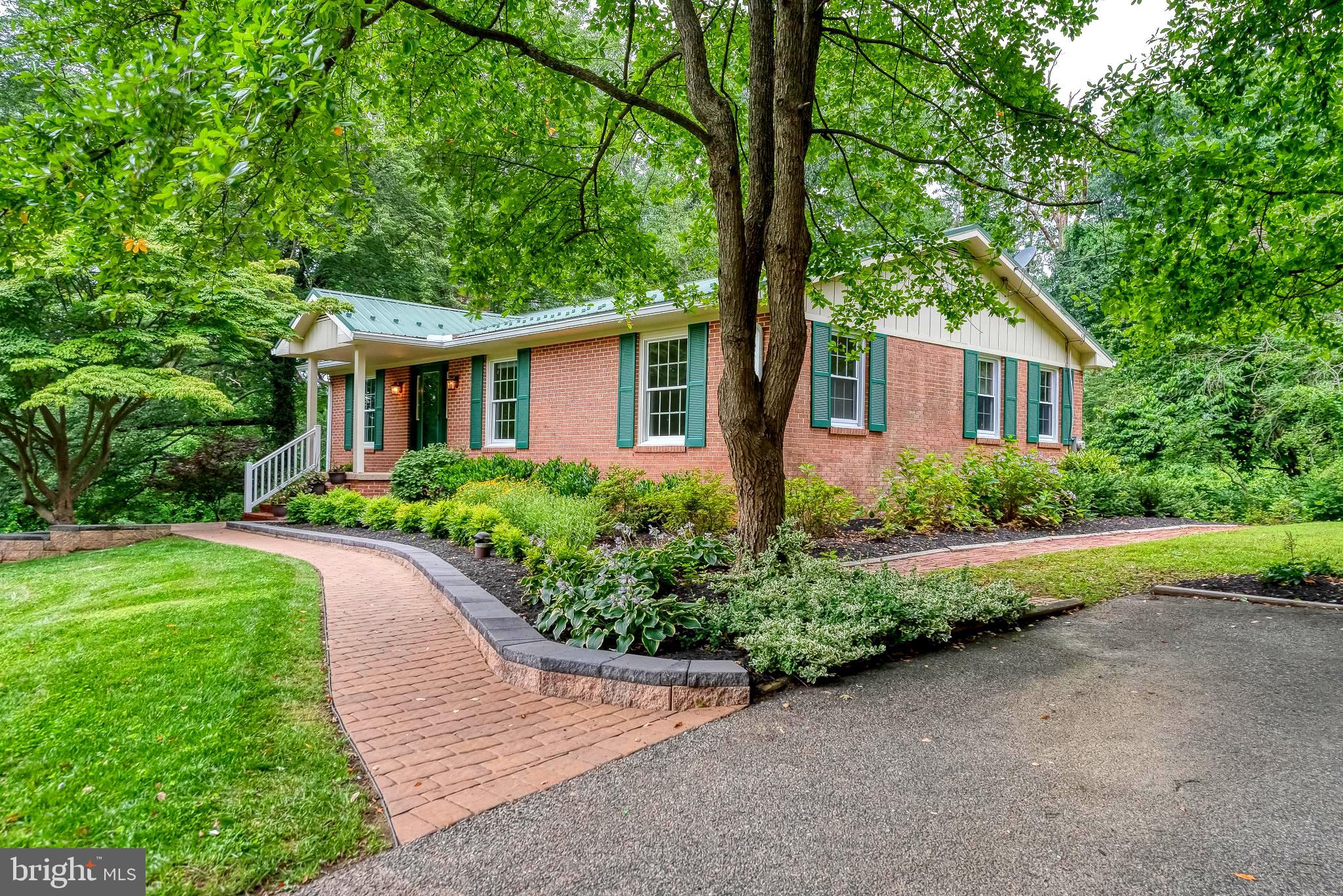 3622 Miller Road Street, MD 21154 - Photo 1 of 48 a front view of a house with a yard and a garden
