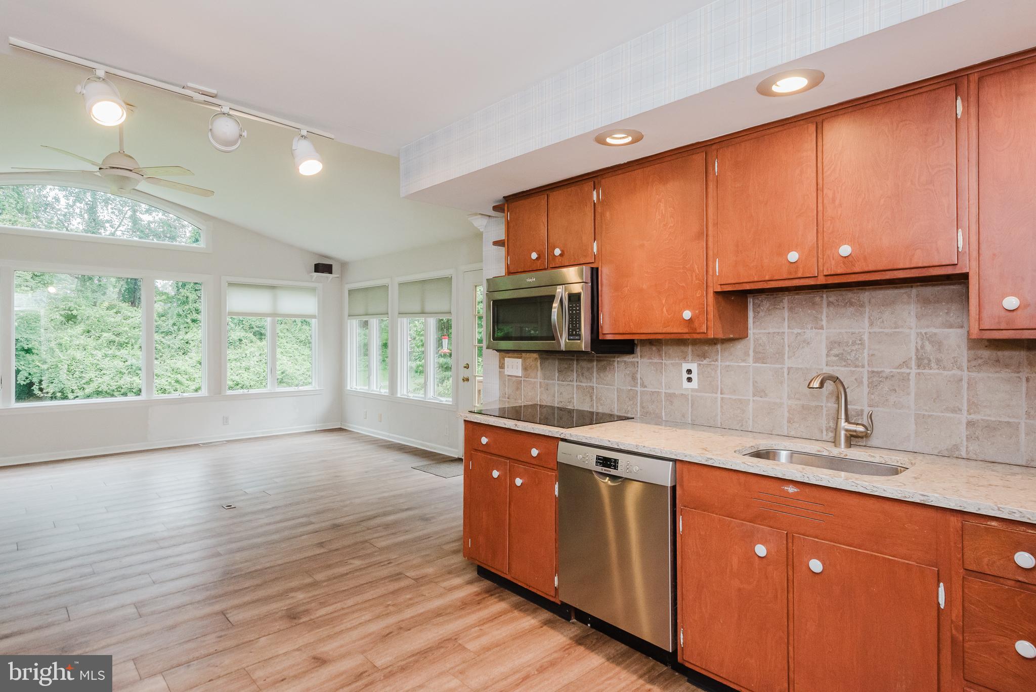 3622 Miller Road Street, MD 21154 - Photo 12 of 48 a kitchen with stainless steel appliances granite countertop a sink a stove cabinets and a wooden floor