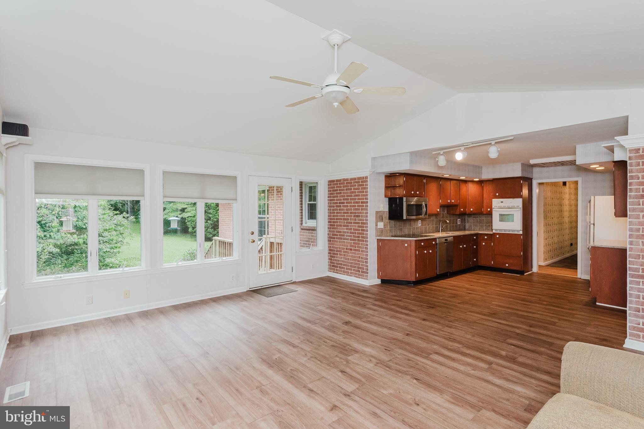 3622 Miller Road Street, MD 21154 - Photo 18 of 48 a large living room with stainless steel appliances wooden floors and kitchen view
