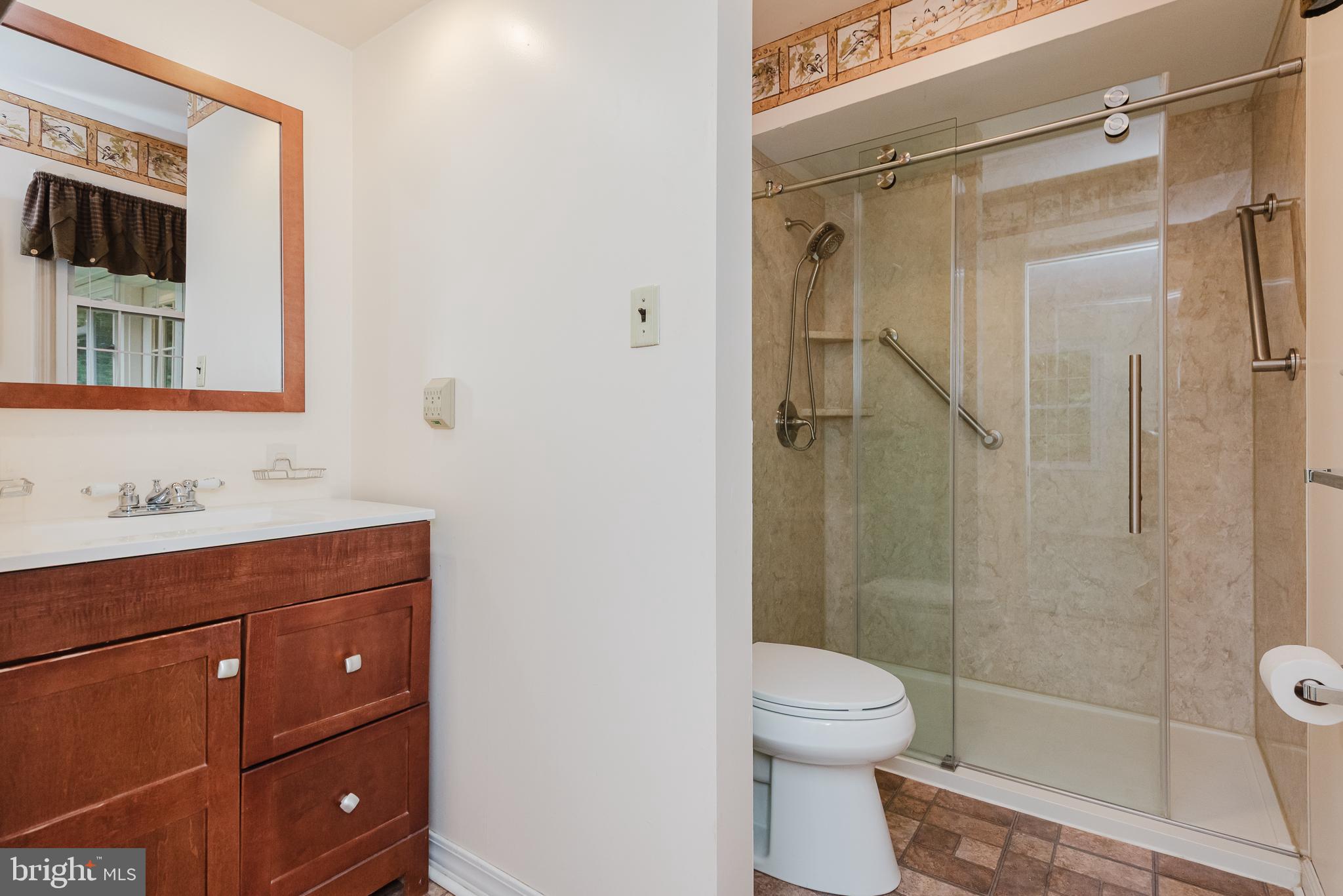 3622 Miller Road Street, MD 21154 - Photo 23 of 48 a bathroom with a shower a sink a toilet and mirror