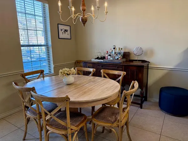 a view of a dining room with furniture and chandelier
