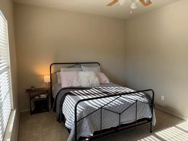 a bedroom with a bed and a window
