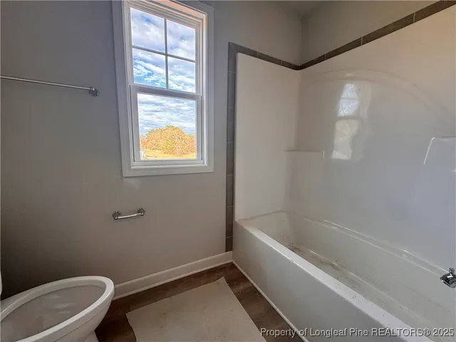 a bathroom with a tub and window