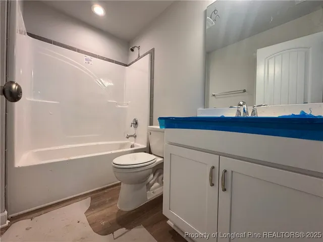 a bathroom with a toilet sink and shower