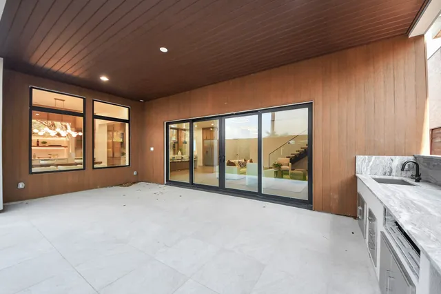 a view of an empty room with a fireplace and a large window